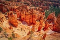 Hoodoos and eroded sand - Looking down into Bryce Canyon with tourists on road way down below Royalty Free Stock Photo