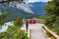 Hoodoos viewpoint at Banff National Park, with the iconic red chairs, with two unidentifiable tourists sitting and enjoying the Royalty Free Stock Photo