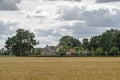 Farmhouse and a field of barley