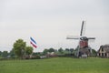 Hoogmade,The Netherlands,07-12-2022.Farmers protest.Upside down Dutch flag next to windmill