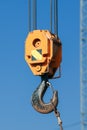 The hook of a crane lifting a big weight on a construction site. Industrial landscape. Royalty Free Stock Photo