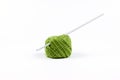 The hook is inserted into a ball of green thread. Knitting. Isolate on a white background