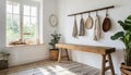 Hook wall mounted coat rack above wooden bench. Rustic country, farmhouse interior design of modern entryway