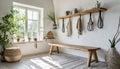 Hook wall mounted coat rack above wooden bench. Rustic country, farmhouse interior design of modern entryway