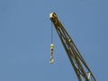 Hook of a yellow crane in the harbor of Antwerp Royalty Free Stock Photo
