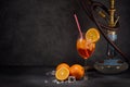 Hookah shisha, glass of cocktail, oranges and ice on dark gray background with copy space. Cocktail Aperol spritz. Hookah bar Royalty Free Stock Photo