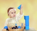 Hooked little girl playing with pyramid. Royalty Free Stock Photo