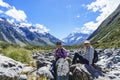 Hooker Valley track with tourists taking a break sitting on rocks on a  great walk of between mountain slopes Royalty Free Stock Photo