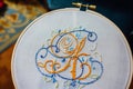 a hoop with a nearly finished embroidered monogram