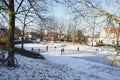 Hoorn, North Holland / Netherlands - March 11, 2012: Children playing hockey on frozen snowy and icy canal and traditional old