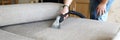 Hoovering sofa with vapor cleaning service at home