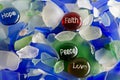 Hope, Faith, Peace and Love on Glass Stones with Sea Glass Royalty Free Stock Photo