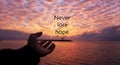 Hope Inspirational quote - Never lose hope. With one human hand open reaching the sun arise. With dramatic colorful sunrise sunset Royalty Free Stock Photo