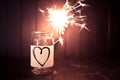 Hope for love, still life with heart jar and burning sparkler Royalty Free Stock Photo