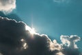 Hope is not lost. sun rising under dark clouds against blue sky Royalty Free Stock Photo