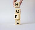 Hope symbol. Concept word Hope on wooden cubes. Businessman hand. Beautiful white background. Business and Hope concept. Copy Royalty Free Stock Photo