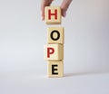 Hope symbol. Concept word Hope on wooden cubes. Businessman hand. Beautiful white background. Business and Hope concept. Copy Royalty Free Stock Photo