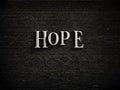 hope text in black letters on dark wall background