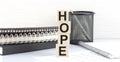 HOPE text on wooden block with notebooks on white background Royalty Free Stock Photo