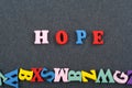 HOPE word on black board background composed from colorful abc alphabet block wooden letters, copy space for ad text. Learning Royalty Free Stock Photo