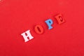 HOPE word on red background composed from colorful abc alphabet block wooden letters, copy space for ad text. Learning english Royalty Free Stock Photo