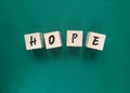 Hope word on wood block with green background Royalty Free Stock Photo