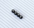 Hope word written with black circle letters isolated on a white lined paper with copy space Royalty Free Stock Photo