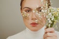 Hope. Young woman with flowers and Hope inscription on adhesive plaster, female face close up