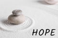 Hope. Zen garden stones on white sand with pattern Royalty Free Stock Photo