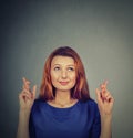 Hopeful beautiful woman crossing her fingers, eyes closed, hoping Royalty Free Stock Photo