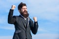 Hopeful and confident about future. Man bearded optimistic businessman wear formal suit sky background. Success and luck Royalty Free Stock Photo