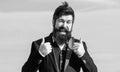 Hopeful and confident about future. Thumbs up gesture. Man bearded optimistic businessman wear formal suit sky