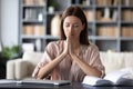 Hopeful employee sitting at table with folded hands. Royalty Free Stock Photo