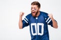 Hopeful excited man fan in blue t-shirt standing isolated Royalty Free Stock Photo