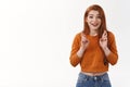 Hopeful happy cheerful urban redhead girl wear cropped sweater cross fingers good luck smiling anticipating positive