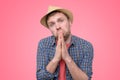 Hopeful man in summer hat join hands in prayer thanking asking for best