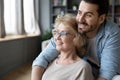 Hopeful mature mother and adult son visualizing at home Royalty Free Stock Photo