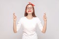 hopeful portrait of beautiful emotional young woman in white t-shirt with glasses, red lips and head band looking at camera with Royalty Free Stock Photo