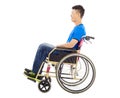 Hopeful young man sitting on a wheelchair in studio