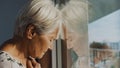 Hopeless elderly woman, feeling loneliness during the lockdown. Vulnerable group and mental health issues