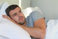 Hopeless man lying down in bed Royalty Free Stock Photo