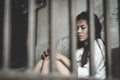 The hopeless slave girl is in a cell. Women violence and abused concept, Imprisonment, Female prisoner,  human trafficking Concept Royalty Free Stock Photo