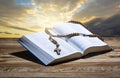 Hopen holy bible and rosary on wooden table Royalty Free Stock Photo
