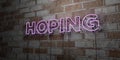 HOPING - Glowing Neon Sign on stonework wall - 3D rendered royalty free stock illustration