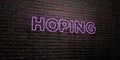 HOPING -Realistic Neon Sign on Brick Wall background - 3D rendered royalty free stock image