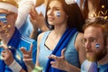 Hoping to win. Tense moment. Young woman crossing fingers for luck, sport fans cheering up football, soccer team of Royalty Free Stock Photo