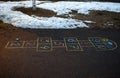 Hopscotch game being drawn with a chalk on the asphalt ground as seen from above Royalty Free Stock Photo