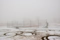 Hora Svateho Sebestiana, Czech republic - November 25, 2018: tennis court under snow in centre of village in winter foggy Ore