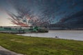 The Horace Wilkinson Bridge over the flowing waters off the Mississippi River with boats on the water, lush green grass and clouds Royalty Free Stock Photo