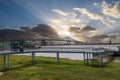 The Horace Wilkinson Bridge over the flowing waters off the Mississippi River with boats on the water, lush green grass and clouds Royalty Free Stock Photo